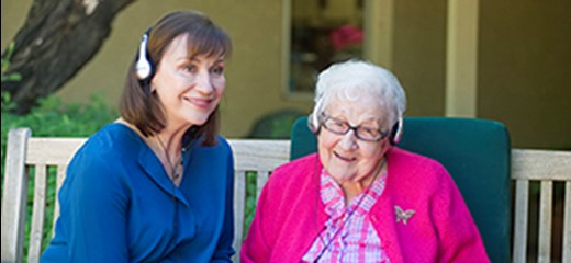 Maribeth Gallagher and patient wearing headphones, listening to music
