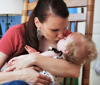 Mother kisses her baby