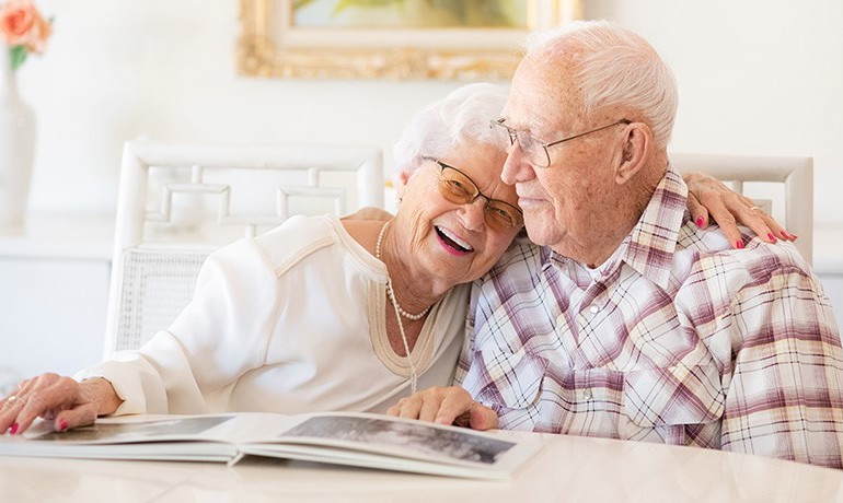 Muryl and Christiane Cole hugging at table