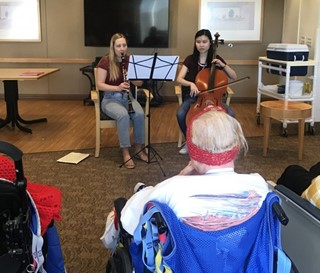 ASU juniors Megan Taylor and Sabrina Leung play music for patients at Hospice of the Valley