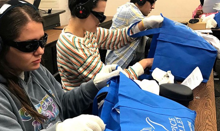 Students wearing sunglasses, gloves, and headphones