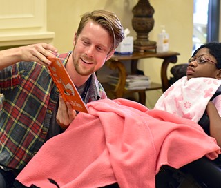 Medical student Chris Bean reads to patient Fatima Faye at Ryan House