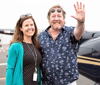 Social worker Andrea Toczek with patient Ron Davis preparing for helicopter ride