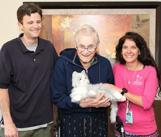 Volunteer Andrew Gaines (left) and social worker Michelle Bales visit with patient Walter “Wally” Brown
