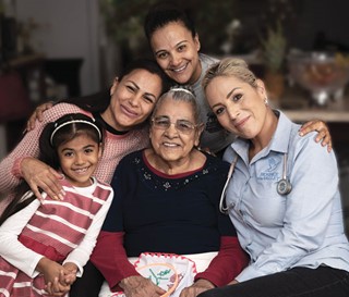 Hispanic family of five hugging