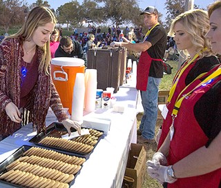 Light Up a Life volunteers setting up cookie table