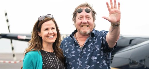 Social worker Andrea Toczek with patient Ron Davis prepare for helicopter ride