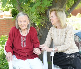 Caretaker comforting female patient