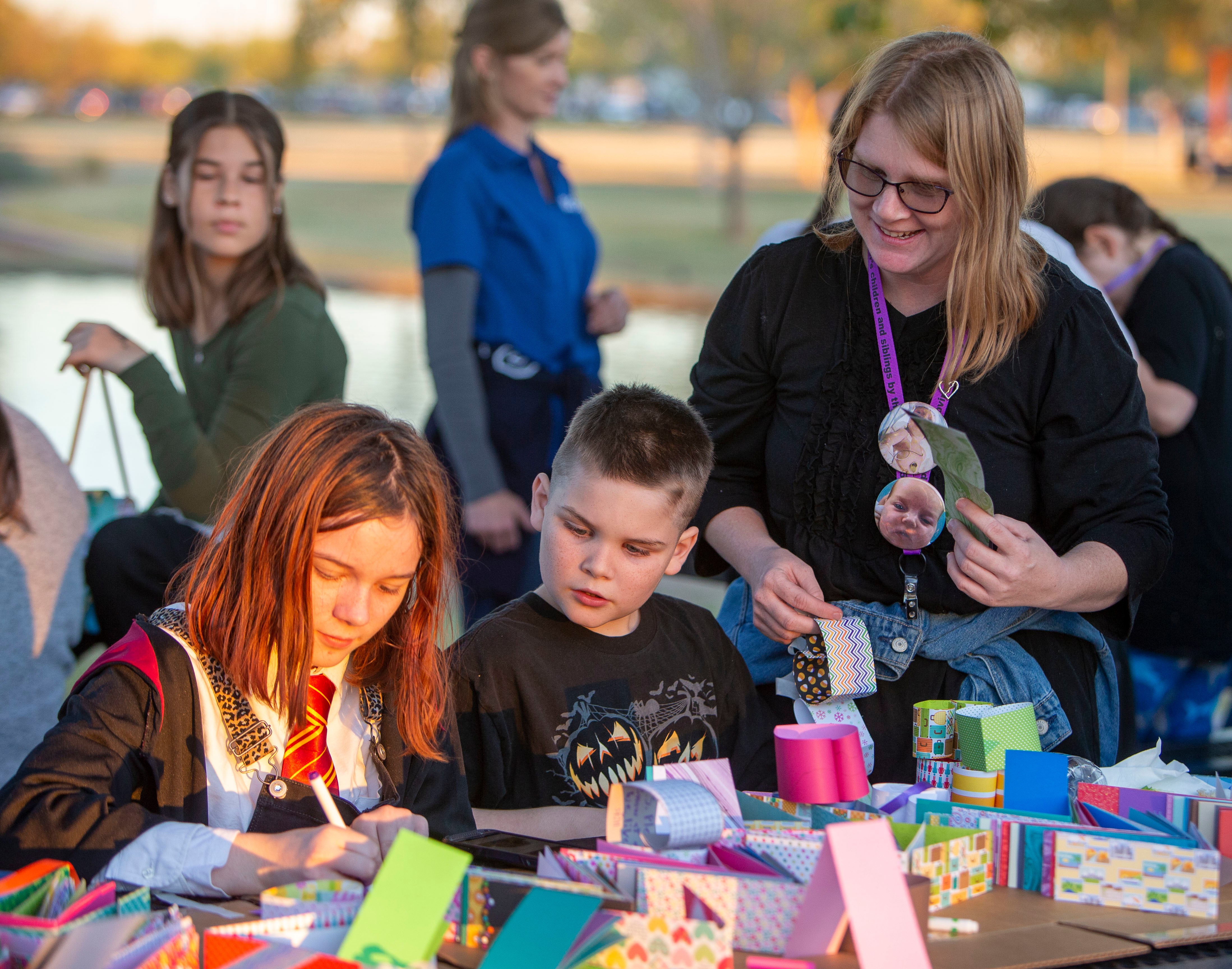 New Song children painting cards in the park