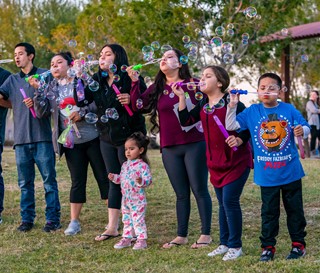 New Song children blowing bubbles in the park