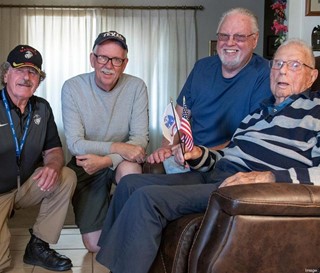 Volunteer Rodney Dehmer with Tom and Jim Dorr and their father, World War II veteran Chester Dorr