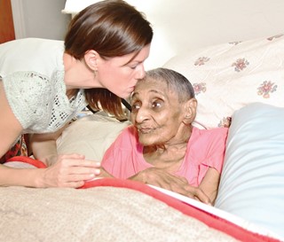 Social worker Erin Butler helps her patient, Tressie Jennings