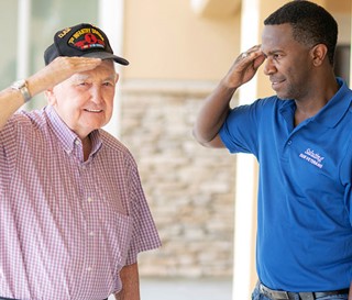 Volunteer Ron Garner salutes veteran Kenneth Hamrick