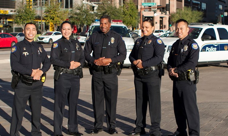 Five Phoenix police officers smiling together