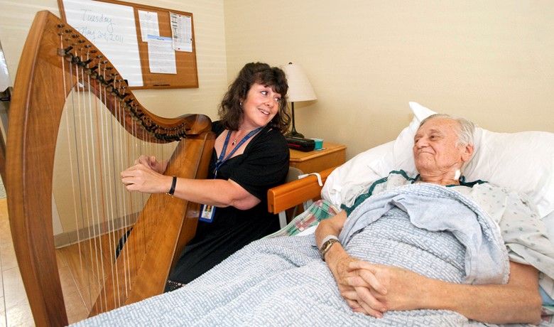 Harpist Joyce Obermeyer plays for patient
