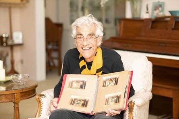 Paul Corbani holding photo album