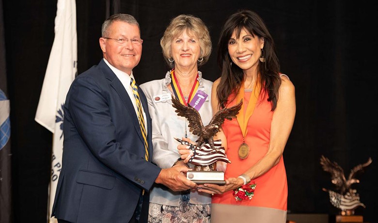 Pat Upah with Denny Bash and Lin Sue Cooney as they hold Copper Eagle Award statue