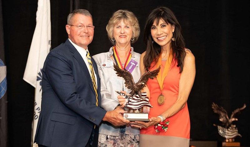 Pat Upah with Denny Bash and Lin Sue Cooney as they hold Copper Eagle Award statue