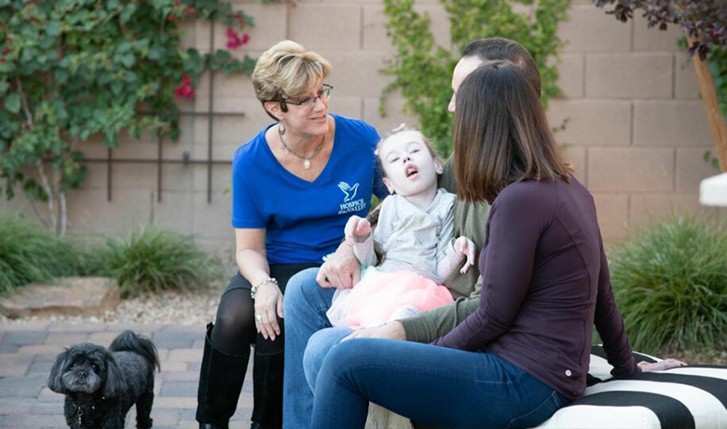 Pam Ruzi sitting with Sean, Jamie and Reesa Stutzman