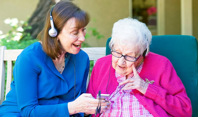 Maribeth Gallagher, DNP with patient listening to music