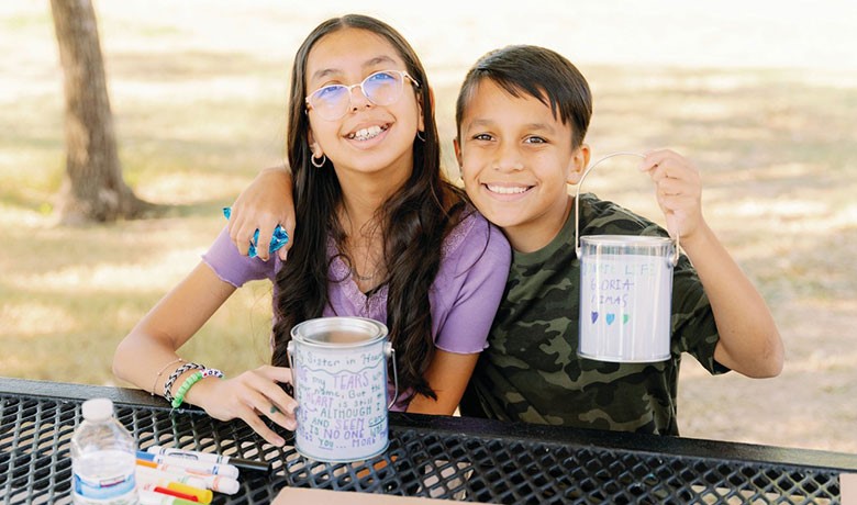 Celeste and Adam Estrada pose with art supplies