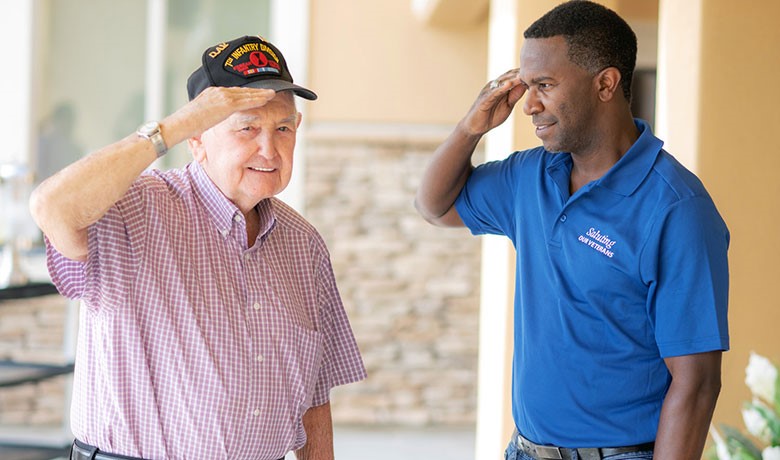 Veteran Kenneth Hamrick and HOV volunteer Ron Garner salute