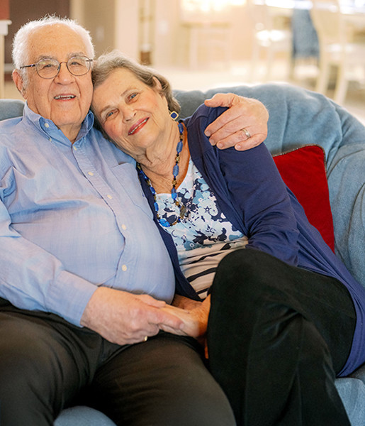 Dementia Care Couple hugging on sofa 
