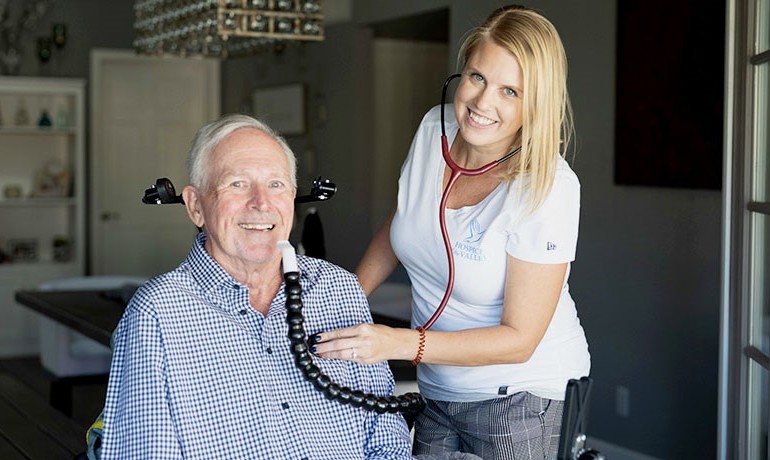 Provider assisting patient with respiratory machine