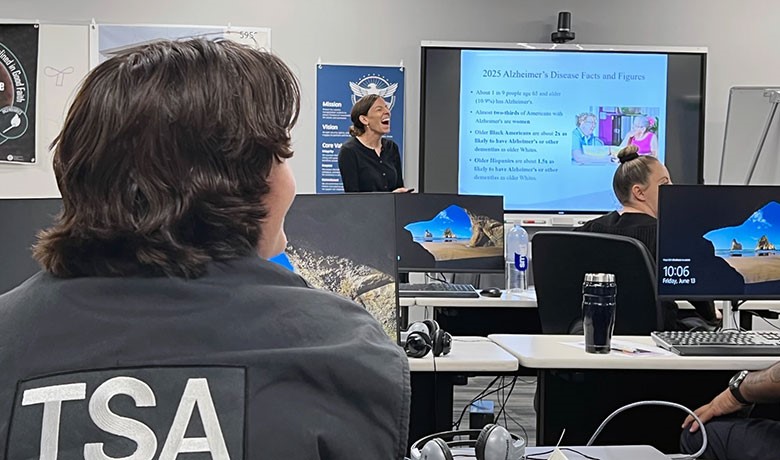 Hospice of the Valley occupational therapist Calli Carlson leads Dementia Moments training for Sky Harbor TSA agents in Phoenix.