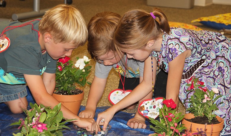 Three children participating in a New Song activity