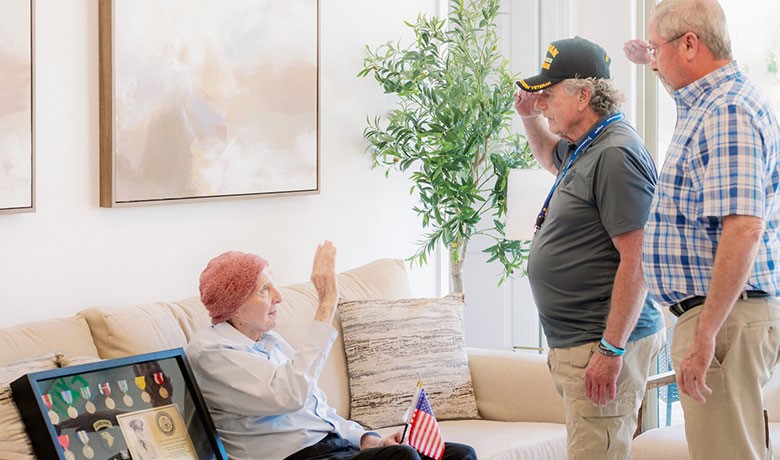 Ned Kent, left, is saluted by Hospice of the Valley volunteer Rodney Dehmer and Kent’s son-in-law, Sam Knott, both Vietnam era veterans.