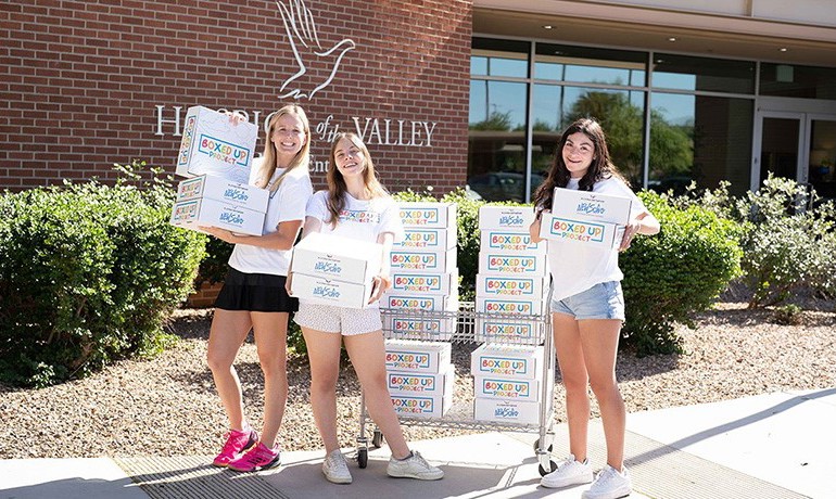 Elina Ferrigno, Sammi Hampton, and Milan Coraggio-Sewell with the grief support boxes they created.