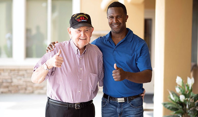 Volunteer Ron Garner and veteran Kenneth Hamrick smiling and giving thumbs up sign