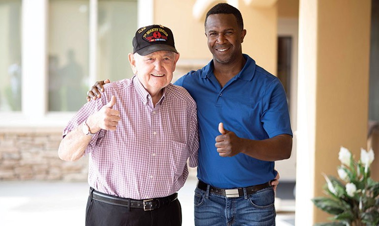Volunteer Ron Garner and veteran Kenneth Hamrick smiling and giving thumbs up sign