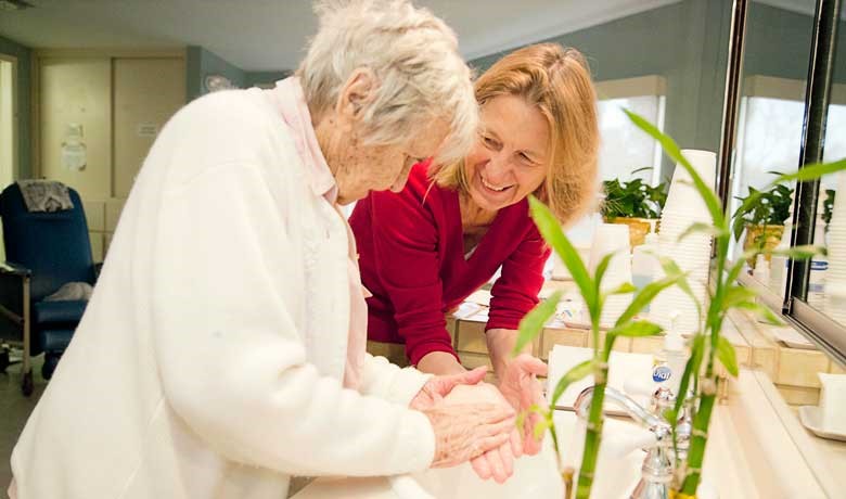 Dr. Hamilton washing hands with a patient. 