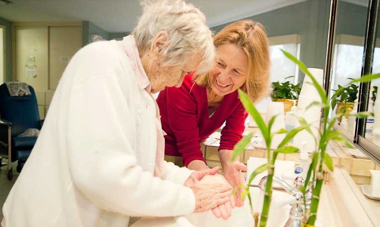 Dr. Hamilton washing hands with a patient. 