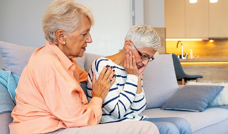 Woman consoles another woman