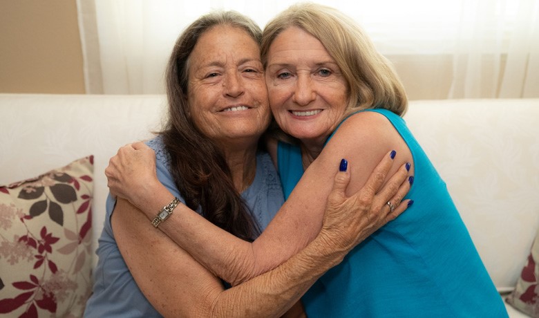 Betty Schecker and Darlene Ferjak embracing