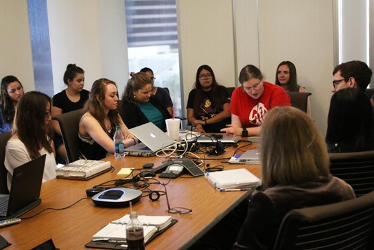 ASU students gathered together at a classroom table 