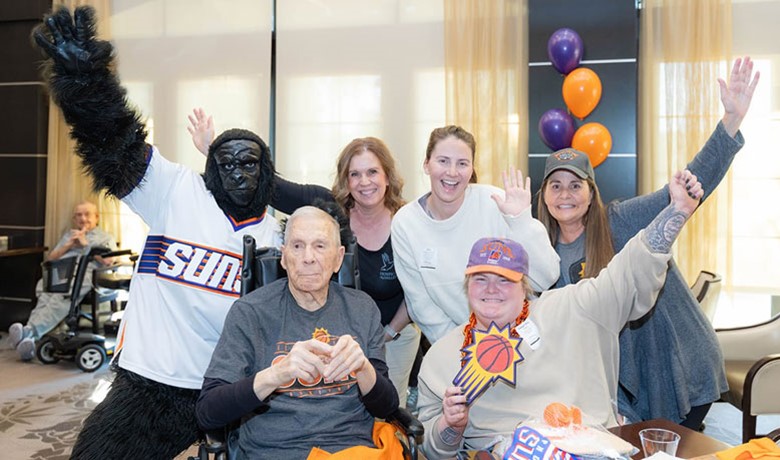 Phoenix suns gorilla mascot poses with HOV employees and patients