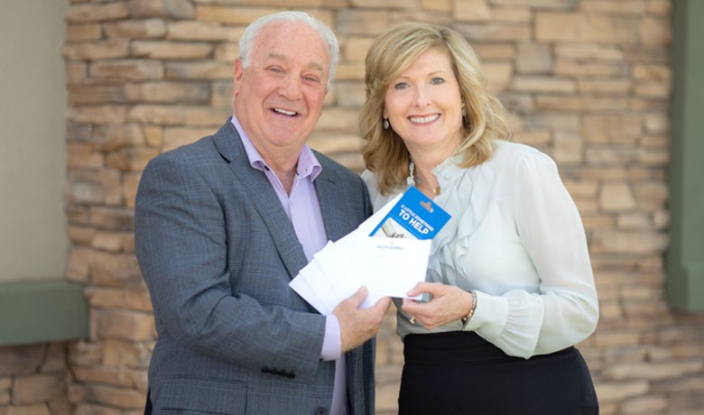Executive Director Debbie Shumway recognizes Jeff Lewis for his 10,000th grocery gift card donation in seven years. Over 2,000 recipients have been Hospice of the Valley cancer patients.