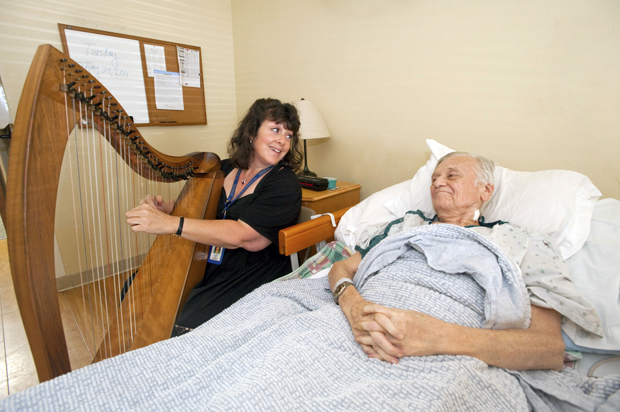 Harpist Joyce Obermeyer playing for patient