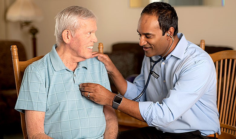 Dr. Gobi assisting a patient