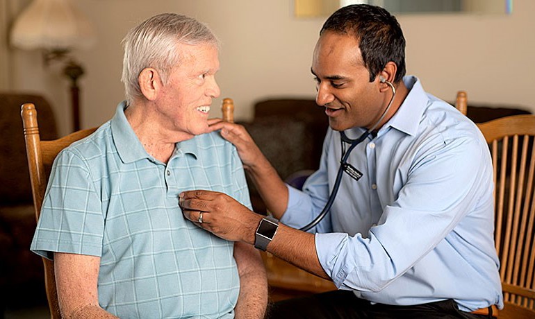 Dr. Gobi assisting a patient