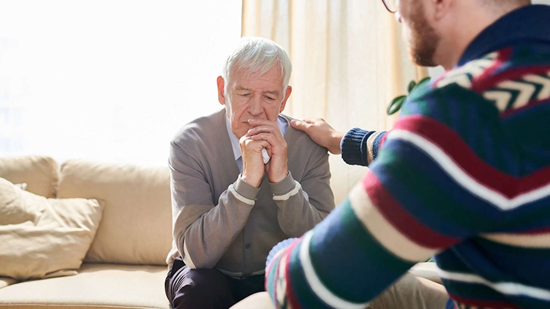 Man helping elderly cope with grief