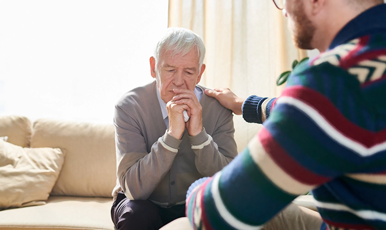 Man helping elderly cope with grief