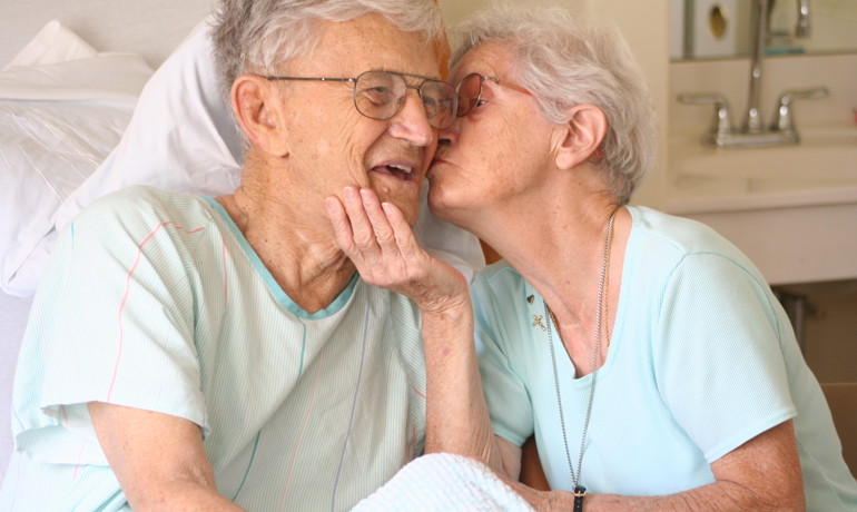 Wife kissing husband on the cheek