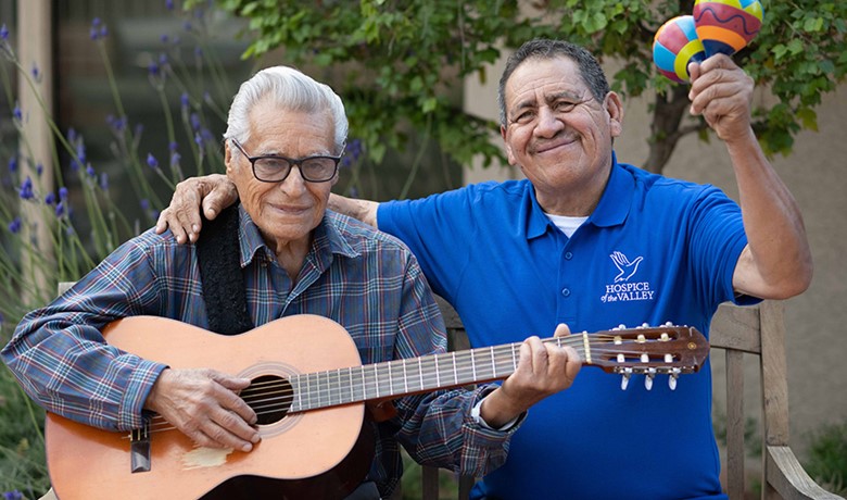 Guadalupe Villegas Avina and patient Feliciano playing guitar