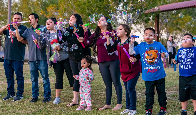 New Song Center families blowing bubbles and event
