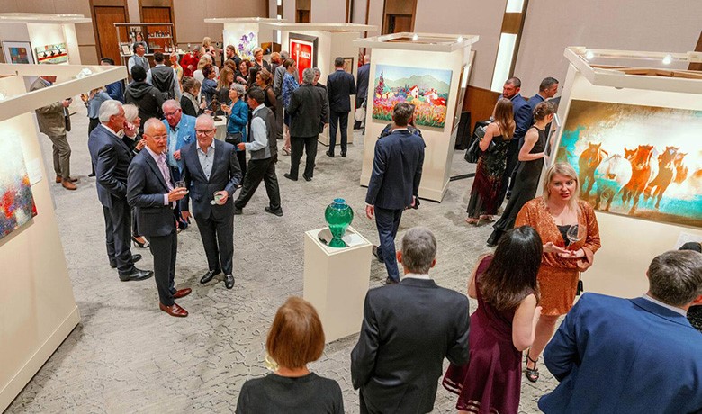 Guests mingle among artwork displays at the event